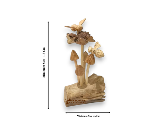 Two hand-carved wooden bees with a wildflower and mushroom cluster on a natural driftwood base