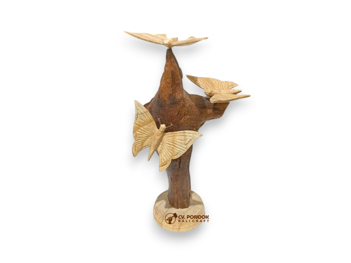 Three hand-carved wooden butterflies arranged on a tall natural rootwood tabletop sculpture