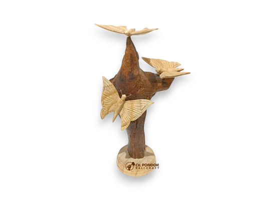 Three hand-carved wooden butterflies arranged on a tall natural rootwood tabletop sculpture