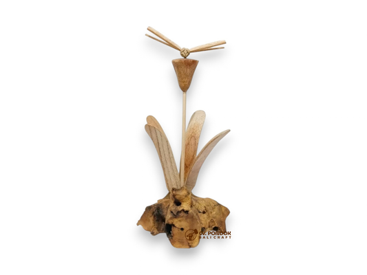 Hand-carved wooden dragonfly hovering above a tall flower and leaves on a naturally shaped wood base