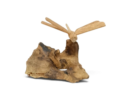 Hand-carved wooden dragonfly with four extended wings on a natural wood base, minimum size 7 by 5 cm