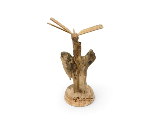 Hand-carved wooden dragonfly with four extended wings on a natural wood trunk and round base, minimum size 14 by 9 cm