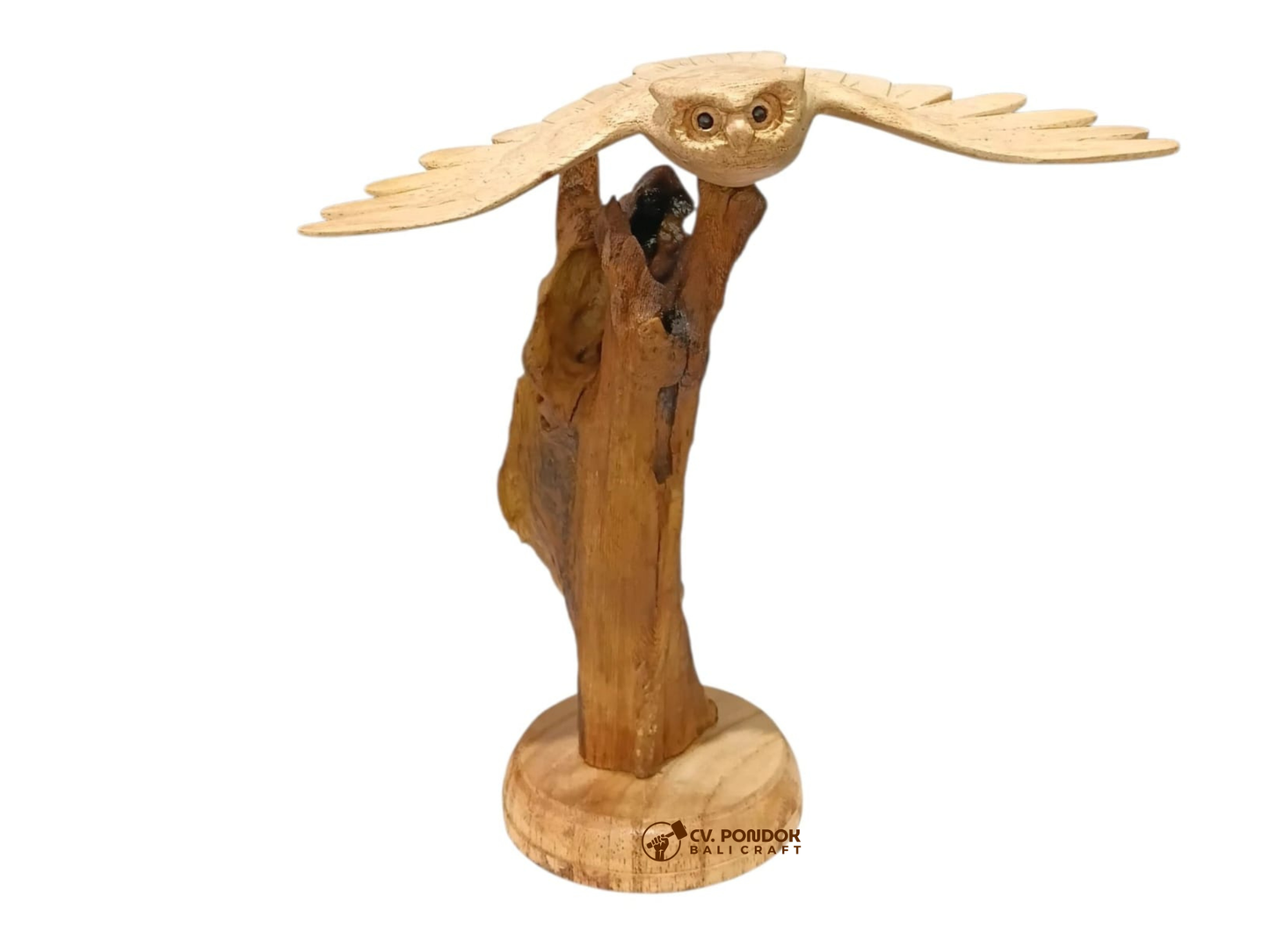 Hand-carved wooden flying owl with extended wings displayed on a natural rootwood trunk and round wooden base