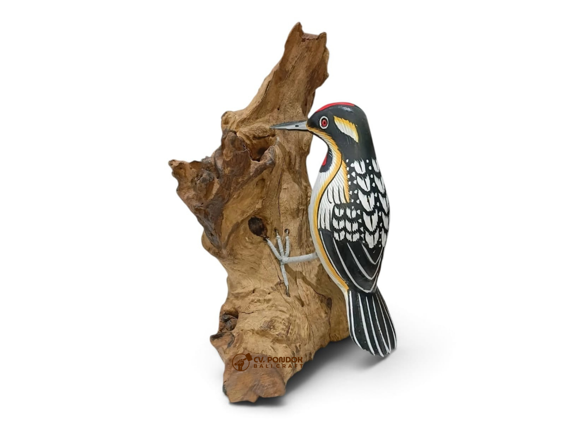 Hand-painted black-and-white wooden woodpecker with a red crown clinging to a natural rootwood trunk