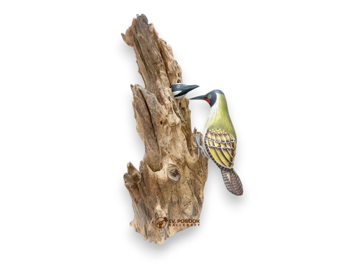 Hand-painted wooden woodpecker feeding its chick in a nest opening on a tall natural rootwood trunk