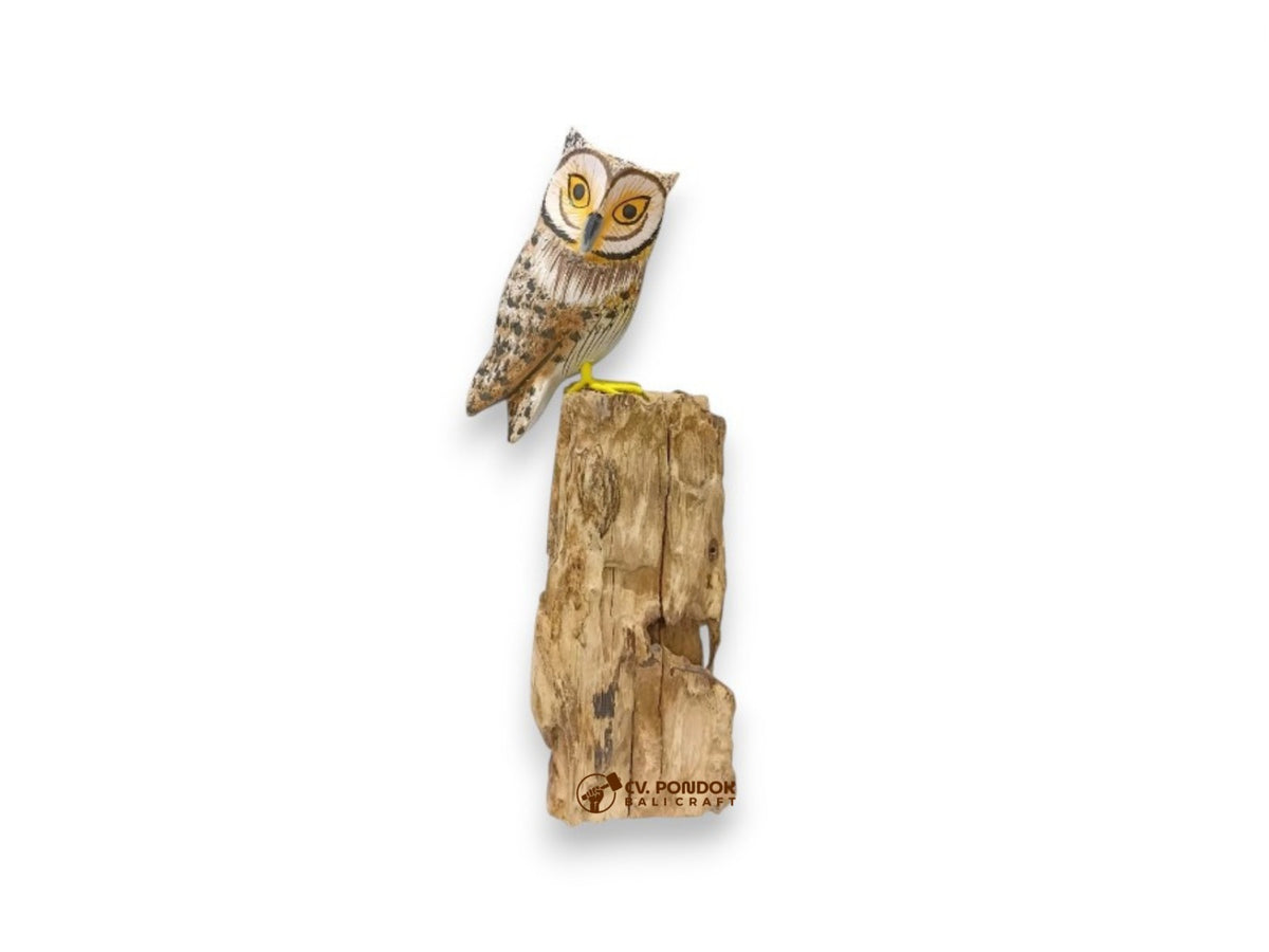 Hand-painted brown wooden owl with large yellow eyes perched on top of a tall natural rootwood trunk